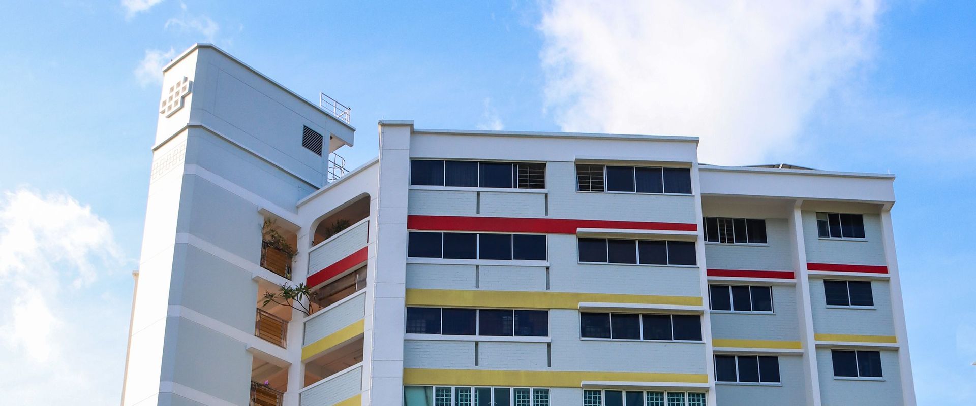 Colourful HDB block against a blue sky in Singapore