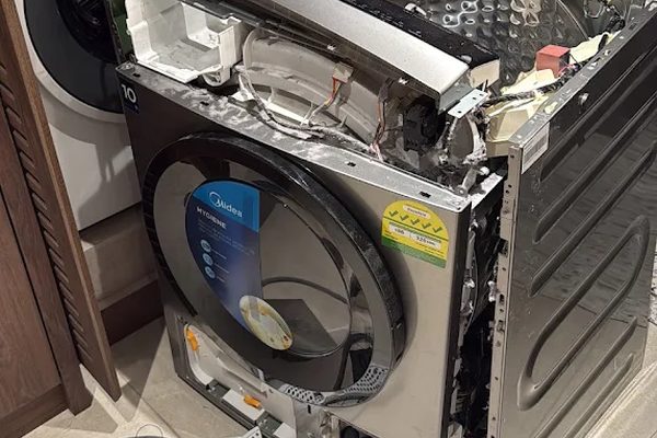 Dryer cabinet removed for a full internal repair next to the washing machine