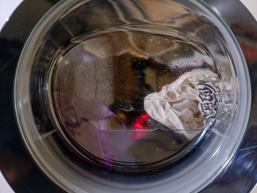 Wet clothes inside a front-load washing machine drum