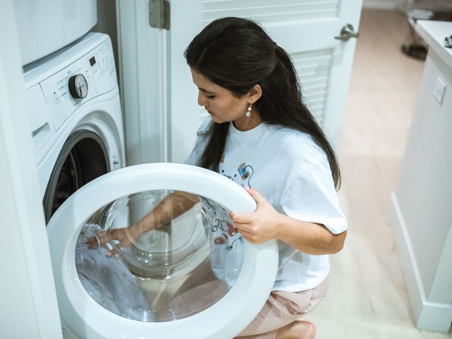 Woman opening a dryer door
