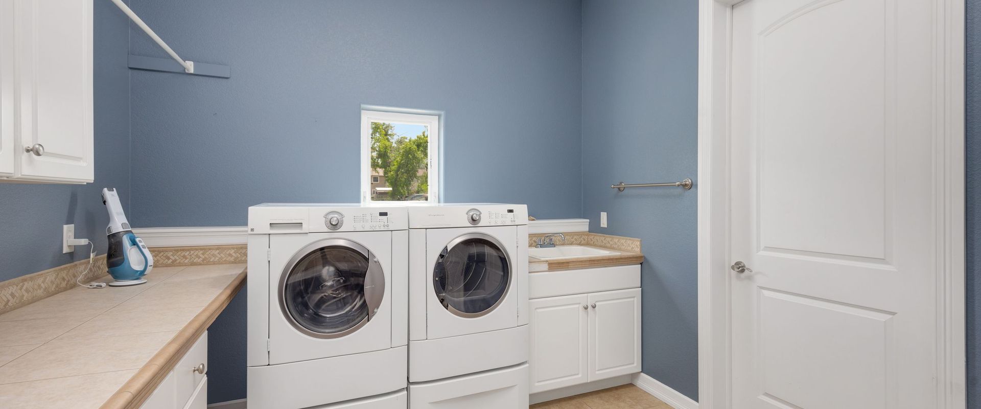 Laundry room with a washing machine and dryer side by side