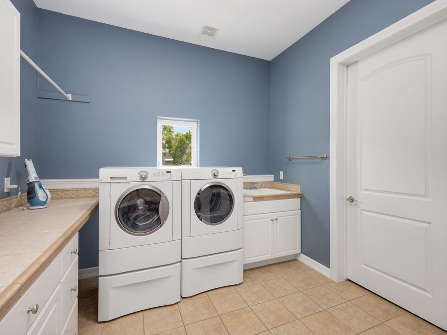 Laundry room with a washing machine and dryer side by side