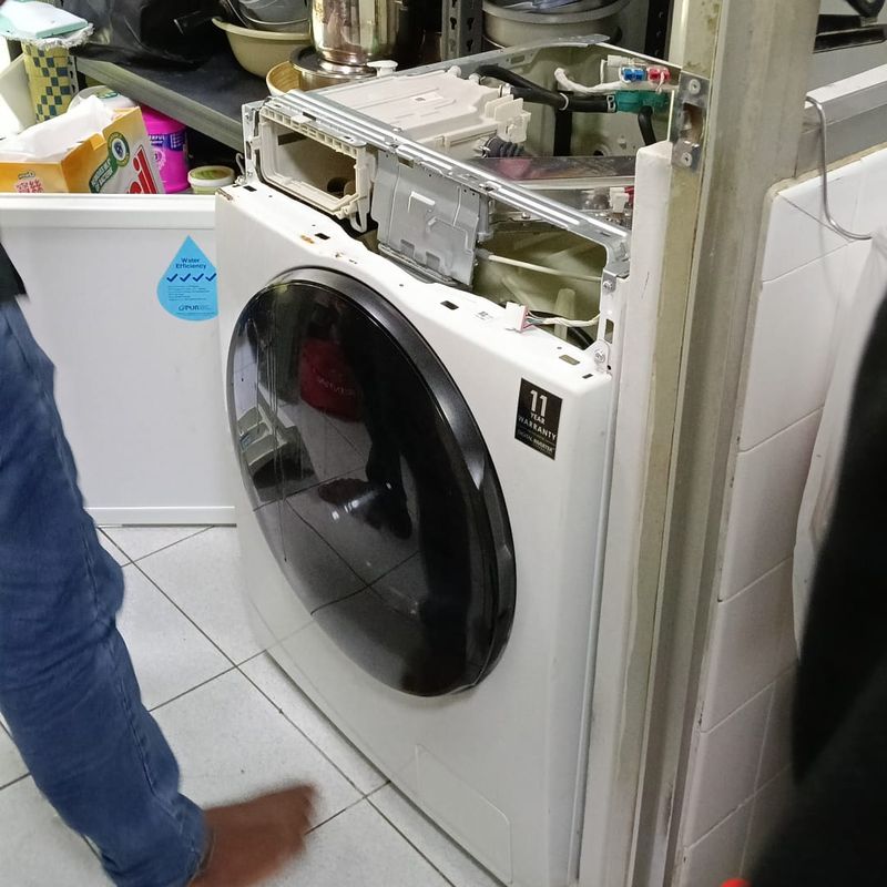 Mike Washer & Dryer Services technician at work on a customer's washing machine
