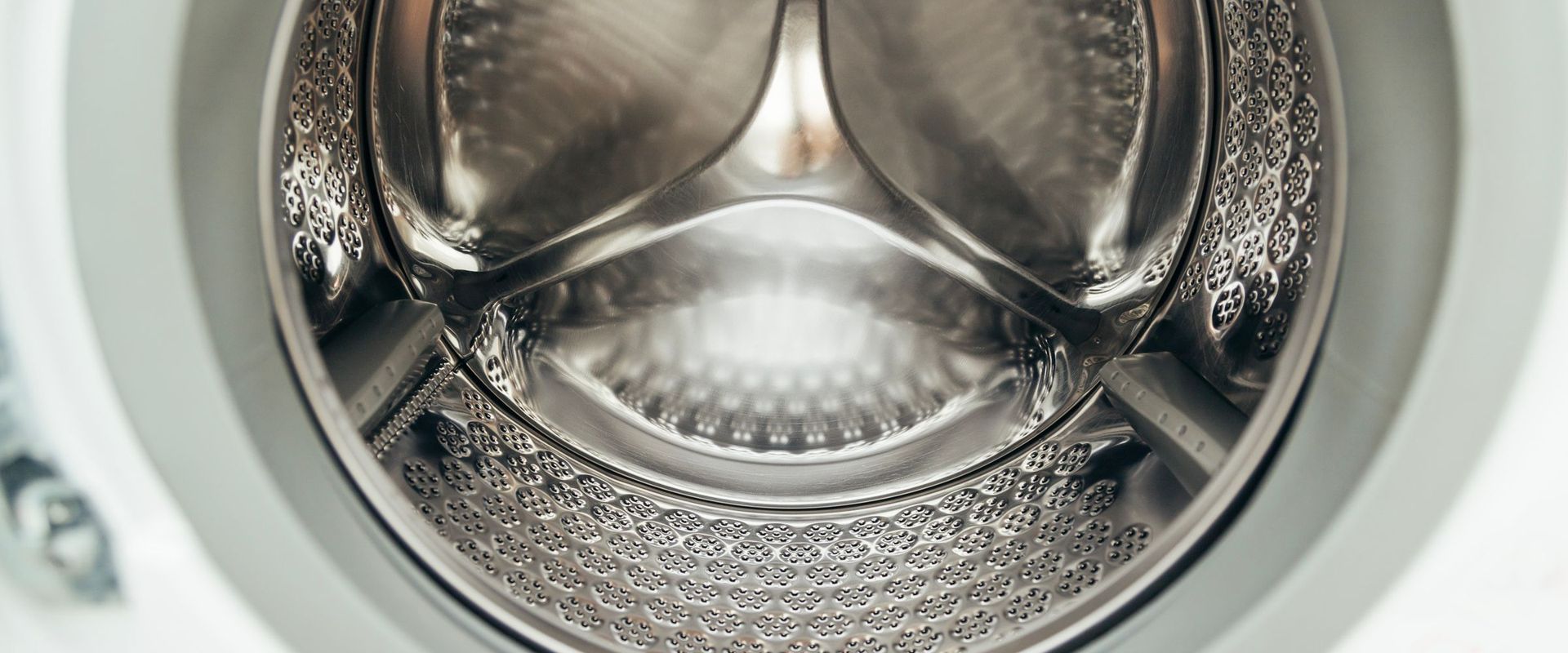 Close-up of a clean stainless steel washing machine drum