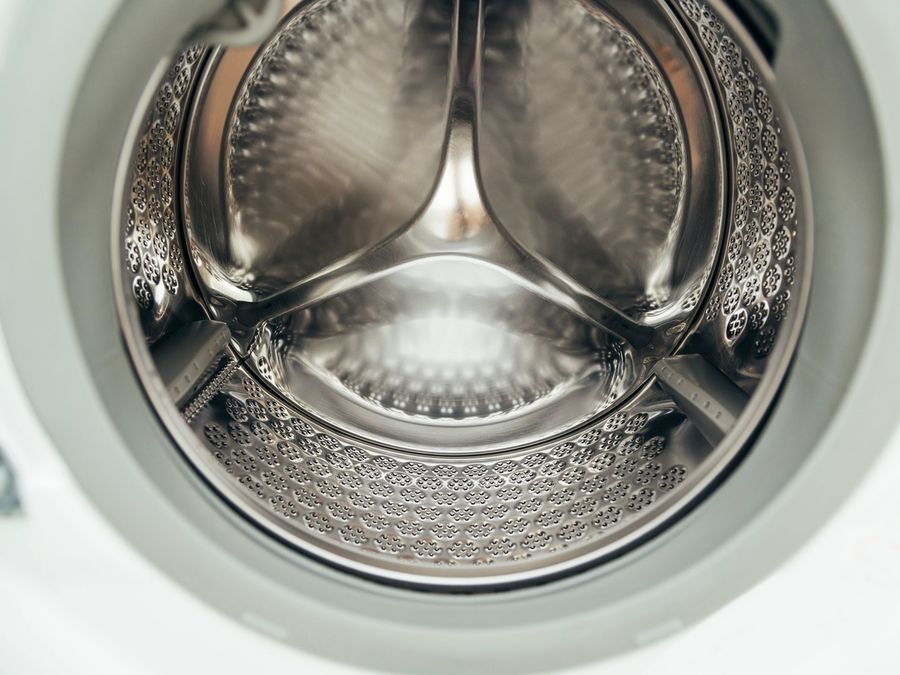 Close-up of a clean stainless steel washing machine drum