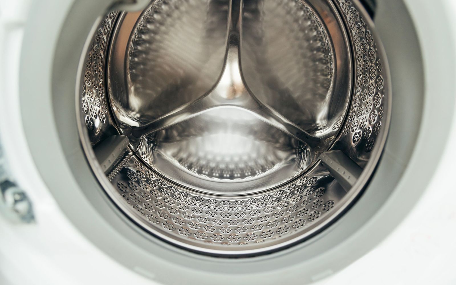 Close-up of a clean stainless steel washing machine drum
